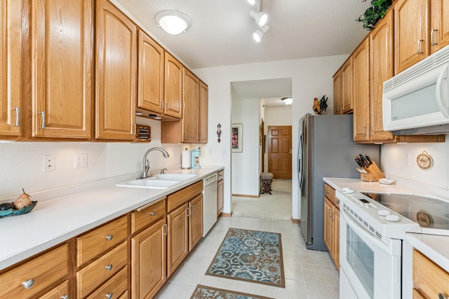 6600 Lyndale Ave S Unit 503, Richfield, MN 55423 - kitchen featuring white appliances, light countertops, light tile patterned floors, track lighting, and brown cabinetry