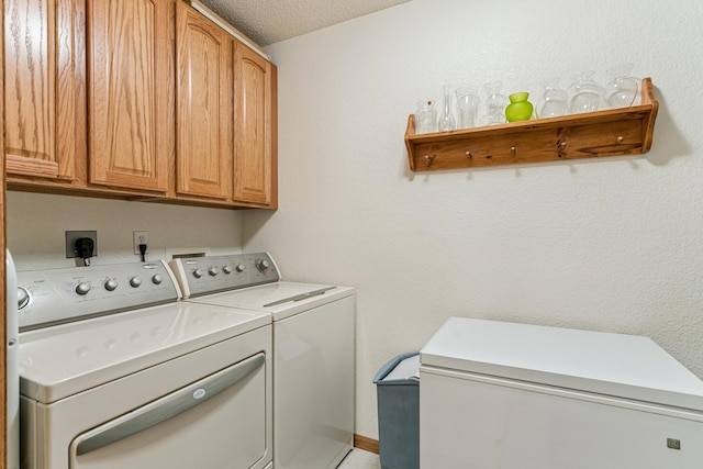 6600 Lyndale Ave S Unit 503, Richfield, MN 55423 - washroom with cabinet space, washing machine and dryer, and a textured ceiling