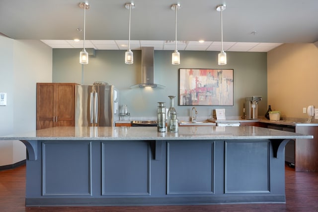 6600 Lyndale Ave S Unit 503, Richfield, MN 55423 - kitchen with wall chimney range hood, a drop ceiling, freestanding refrigerator, a kitchen bar, and light stone counters