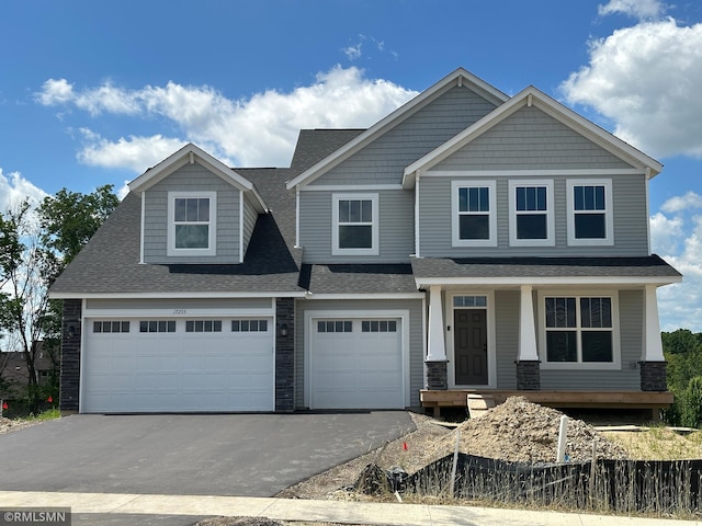 17205 61st St NE, Otsego, MN 55330 - view of front facade with driveway, a porch, a garage, and roof with shingles