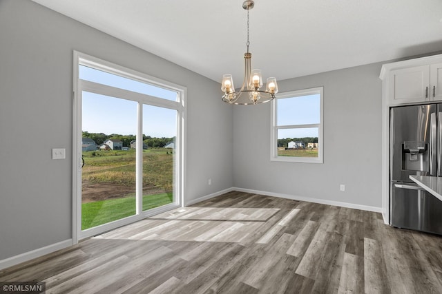 17205 61st St NE, Otsego, MN 55330 - unfurnished dining area featuring wood finished floors and a chandelier