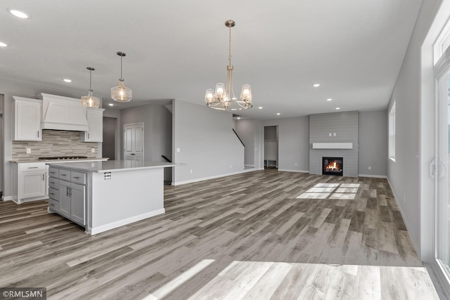 17205 61st St NE, Otsego, MN 55330 - kitchen featuring premium range hood, recessed lighting, white cabinets, backsplash, and light wood-style floors