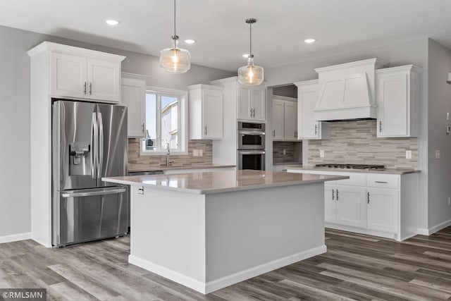 17205 61st St NE, Otsego, MN 55330 - kitchen featuring appliances with stainless steel finishes, custom range hood, white cabinets, recessed lighting, and wood finished floors