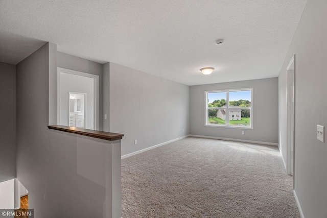 17205 61st St NE, Otsego, MN 55330 - spare room featuring carpet, a smoke detector, and a textured ceiling