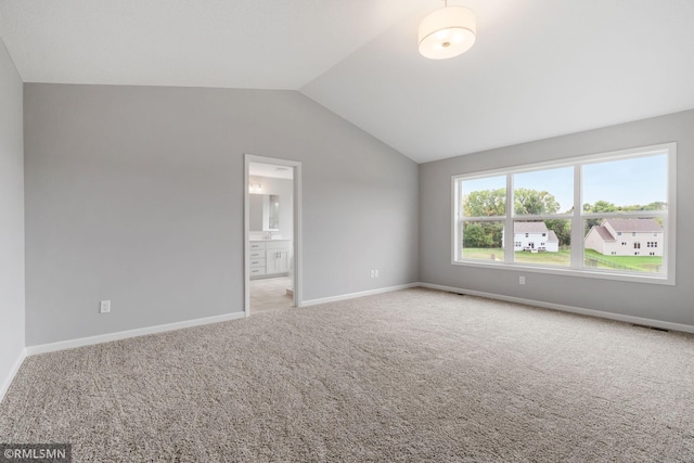 17205 61st St NE, Otsego, MN 55330 - unfurnished bedroom featuring vaulted ceiling, light carpet, and ensuite bathroom