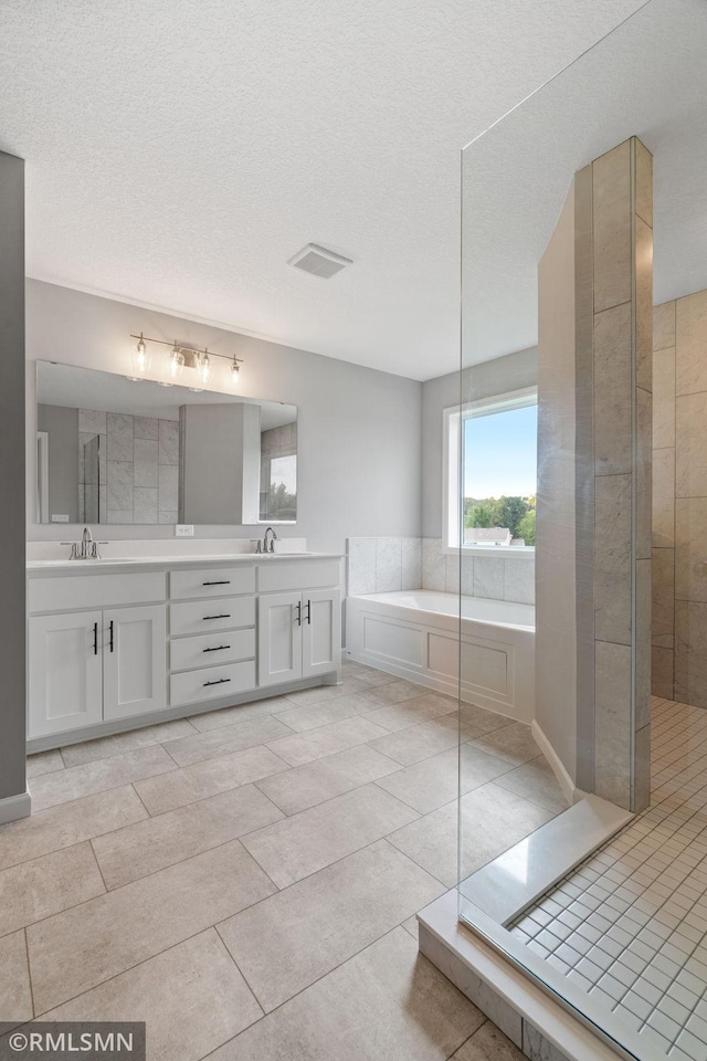 17205 61st St NE, Otsego, MN 55330 - bathroom with a garden tub, double vanity, tile patterned floors, a shower, and a textured ceiling