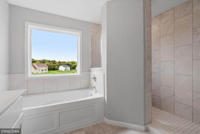 17205 61st St NE, Otsego, MN 55330 - bathroom with plenty of natural light, a bath, tiled shower, and tile patterned flooring