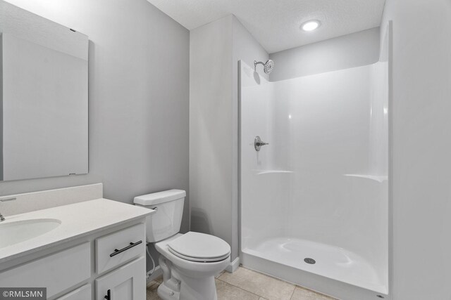 17205 61st St NE, Otsego, MN 55330 - bathroom with vanity, a shower, a textured ceiling, and tile patterned flooring