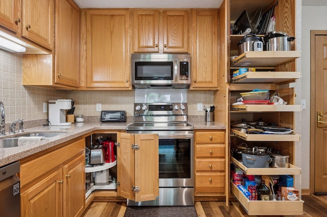 1600 Arundel St Unit 201, Saint Paul, MN 55117 - kitchen featuring appliances with stainless steel finishes, tasteful backsplash, open shelves, and light stone counters