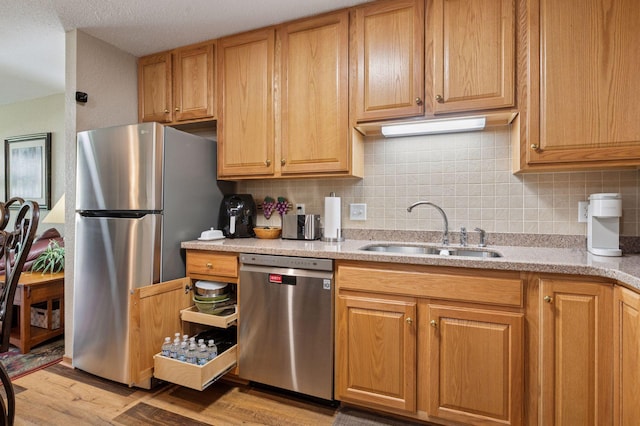 1600 Arundel St Unit 201, Saint Paul, MN 55117 - kitchen featuring stainless steel appliances, light wood-style flooring, backsplash, and light stone countertops