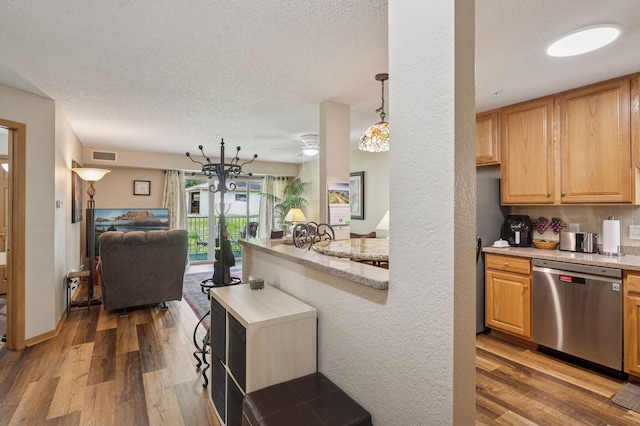 1600 Arundel St Unit 201, Saint Paul, MN 55117 - kitchen featuring stainless steel dishwasher, open floor plan, wood finished floors, a textured ceiling, and tasteful backsplash
