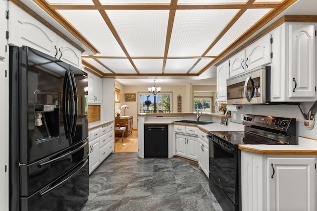 30190 Terryll St, Lindstrom, MN 55045 - kitchen featuring black appliances, a peninsula, a chandelier, white cabinetry, and light countertops