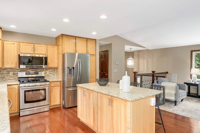 14744 Evergreen St NW, Andover, MN 55304 - kitchen featuring appliances with stainless steel finishes, light brown cabinetry, dark wood-style floors, a breakfast bar area, and recessed lighting