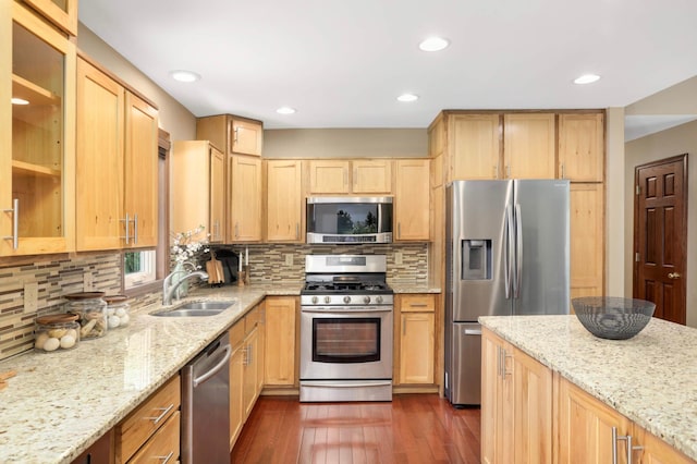 14744 Evergreen St NW, Andover, MN 55304 - kitchen with appliances with stainless steel finishes, glass insert cabinets, light brown cabinetry, light stone counters, and dark wood finished floors