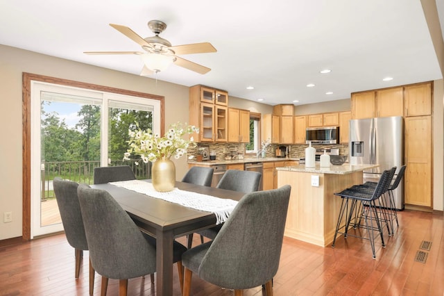 14744 Evergreen St NW, Andover, MN 55304 - dining space with wood finished floors, a ceiling fan, and recessed lighting