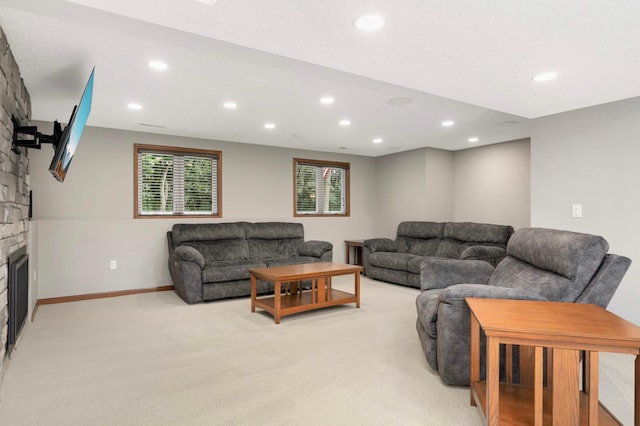 14744 Evergreen St NW, Andover, MN 55304 - living area with recessed lighting, a stone fireplace, light colored carpet, and plenty of natural light