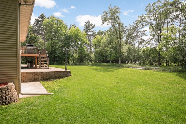 14744 Evergreen St NW, Andover, MN 55304 - view of grassy yard featuring stairway, a wooden deck, a patio, and view of wooded area
