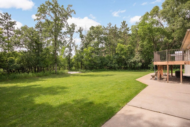 14744 Evergreen St NW, Andover, MN 55304 - view of green lawn featuring a wooden deck, a patio, and view of wooded area
