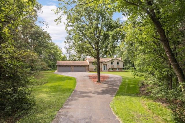 14744 Evergreen St NW, Andover, MN 55304 - tri-level home with asphalt driveway, a front yard, and an attached garage