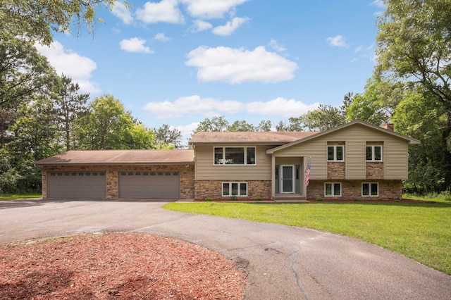 14744 Evergreen St NW, Andover, MN 55304 - view of front facade with driveway, a front lawn, an attached garage, and stone siding