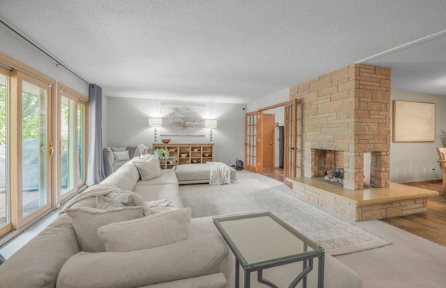 4111 Auburn Dr, Minnetonka, MN 55305 - living area featuring a textured ceiling, a fireplace, and wood finished floors