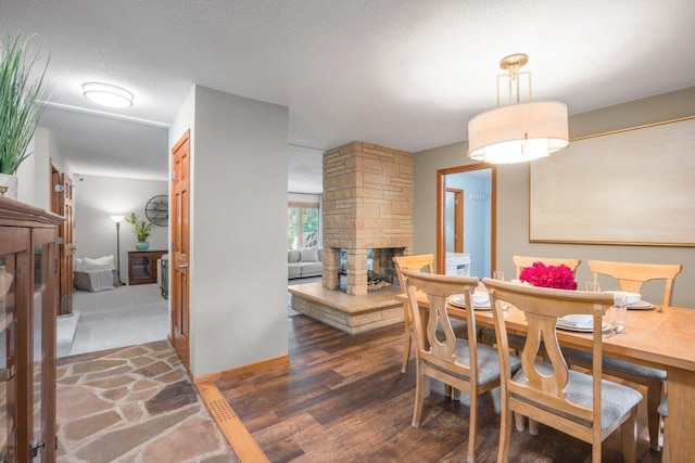 4111 Auburn Dr, Minnetonka, MN 55305 - dining room with a stone fireplace and wood finished floors
