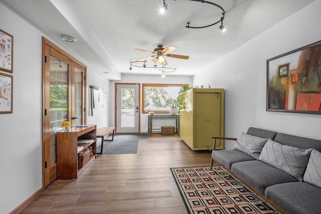4111 Auburn Dr, Minnetonka, MN 55305 - living area with dark wood-style flooring, ceiling fan, a textured ceiling, and track lighting