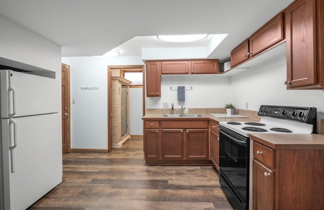 4111 Auburn Dr, Minnetonka, MN 55305 - kitchen featuring freestanding refrigerator, black range with electric cooktop, dark wood finished floors, and brown cabinetry
