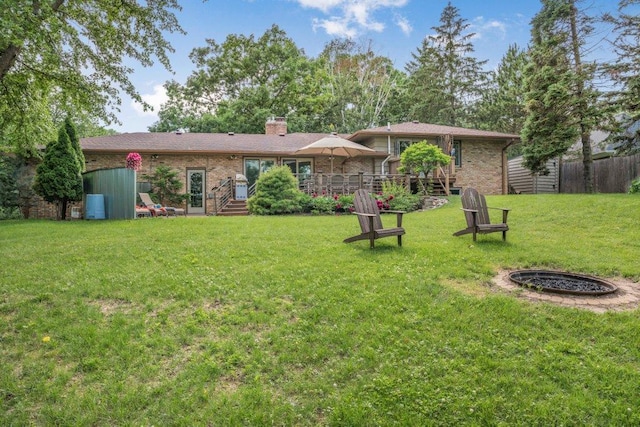 4111 Auburn Dr, Minnetonka, MN 55305 - back of property with a chimney, brick siding, and a storage unit