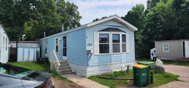 4550 Central Ave NE Unit 1011, Hilltop, MN 55421 - view of front of home featuring a storage shed and entry steps