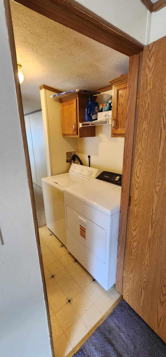 4550 Central Ave NE Unit 1011, Hilltop, MN 55421 - laundry room featuring cabinet space, independent washer and dryer, and a textured ceiling