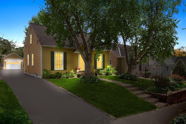 5521 Emerson Ave S, Minneapolis, MN 55419 - view of front of home featuring an outdoor structure, a detached garage, driveway, a front yard, and a shingled roof