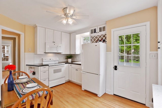5521 Emerson Ave S, Minneapolis, MN 55419 - kitchen with white appliances, plenty of natural light, a wainscoted wall, and white cabinets
