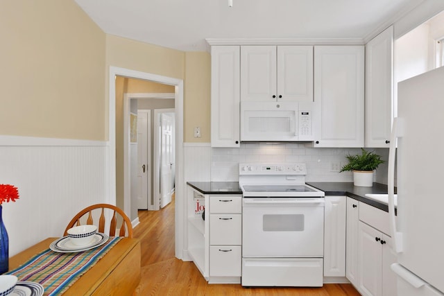 5521 Emerson Ave S, Minneapolis, MN 55419 - kitchen with white appliances, dark countertops, white cabinets, light wood-type flooring, and a wainscoted wall