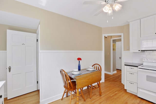 5521 Emerson Ave S, Minneapolis, MN 55419 - dining room with a ceiling fan, wainscoting, and light wood finished floors