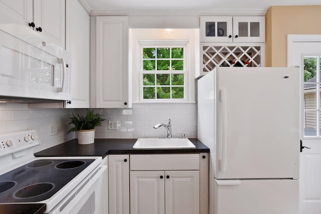 5521 Emerson Ave S, Minneapolis, MN 55419 - kitchen featuring white appliances, dark countertops, tasteful backsplash, white cabinetry, and glass insert cabinets
