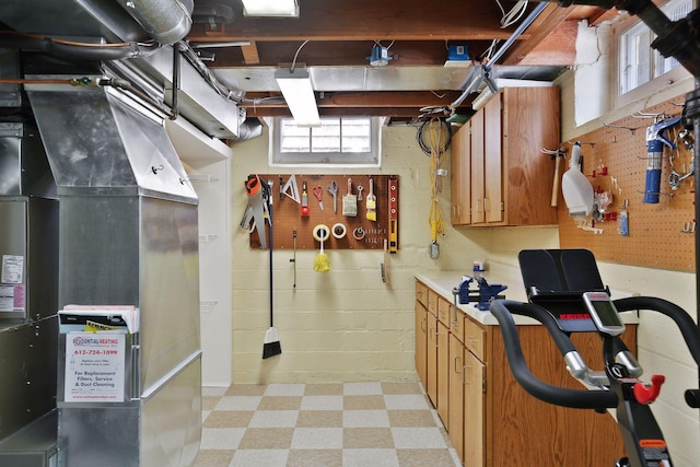 5521 Emerson Ave S, Minneapolis, MN 55419 - basement featuring light flooring, a workshop area, and heating unit