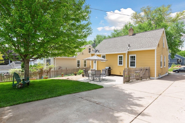 5521 Emerson Ave S, Minneapolis, MN 55419 - back of property featuring a chimney, a patio, and a shingled roof