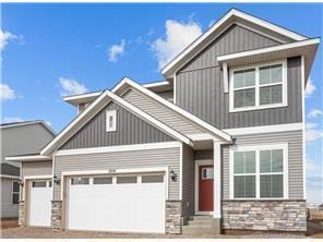 1670 Tyrone Dr, Shakopee, MN 55379 - craftsman-style house with stone siding, entry steps, an attached garage, and driveway