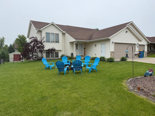 2460 Fox Hollow Ln, Owatonna, MN 55060 - back of property with a garage, a lawn, driveway, and a shingled roof