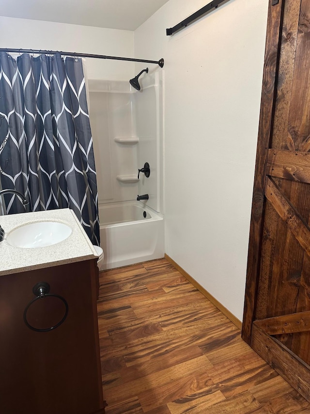 2460 Fox Hollow Ln, Owatonna, MN 55060 - full bath with shower / bath combo with shower curtain, wood finished floors, and vanity