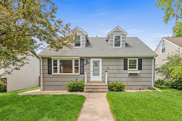3836 Buchanan St NE, Columbia Heights, MN 55421 - cape cod home featuring a front yard and roof with shingles