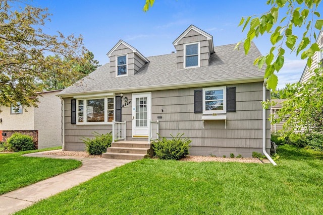 3836 Buchanan St NE, Columbia Heights, MN 55421 - cape cod house featuring a front yard and roof with shingles