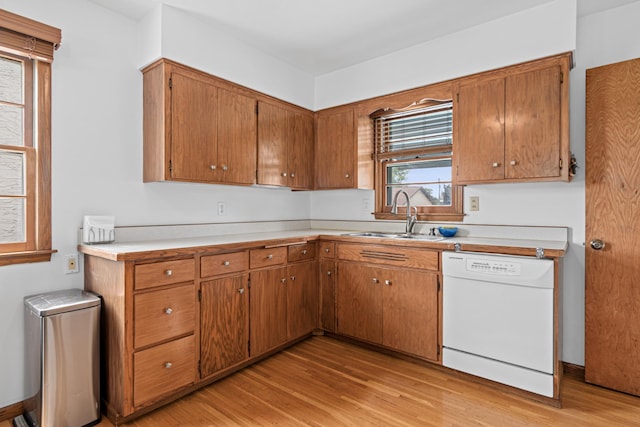 3836 Buchanan St NE, Columbia Heights, MN 55421 - kitchen with white dishwasher, light wood-style flooring, brown cabinetry, and light countertops