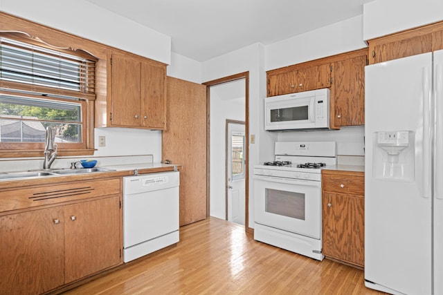 3836 Buchanan St NE, Columbia Heights, MN 55421 - kitchen with white appliances, light wood finished floors, light countertops, and brown cabinets