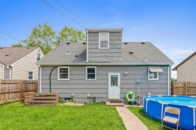 3836 Buchanan St NE, Columbia Heights, MN 55421 - rear view of house with roof with shingles, a fenced backyard, and entry steps