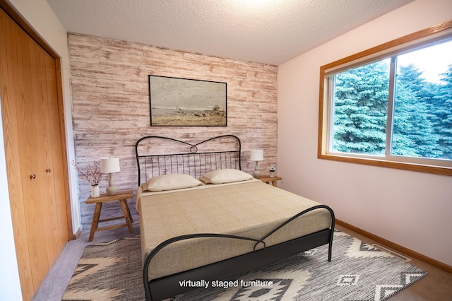 706 Country Club Dr SW, Melrose, MN 56352 - bedroom with a textured ceiling, a closet, and wood walls