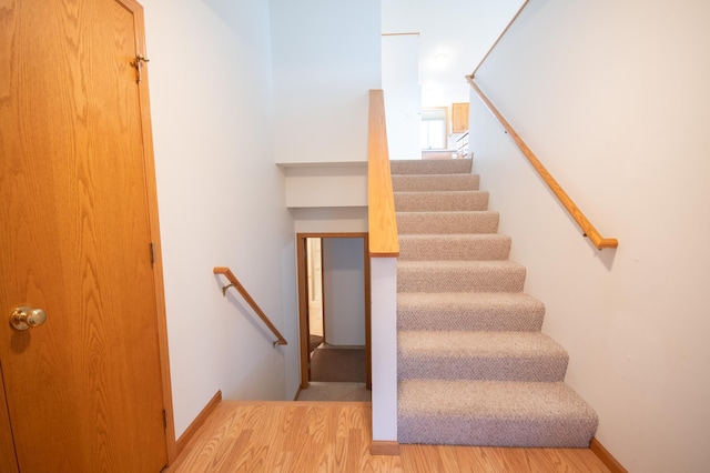 706 Country Club Dr SW, Melrose, MN 56352 - stairs with wood finished floors and baseboards
