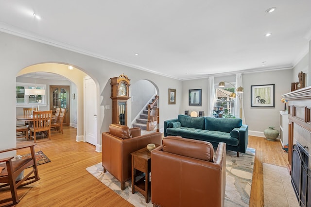 129 50th St, Minneapolis, MN 55419 - living area featuring arched walkways, light wood-style flooring, crown molding, stairs, and recessed lighting