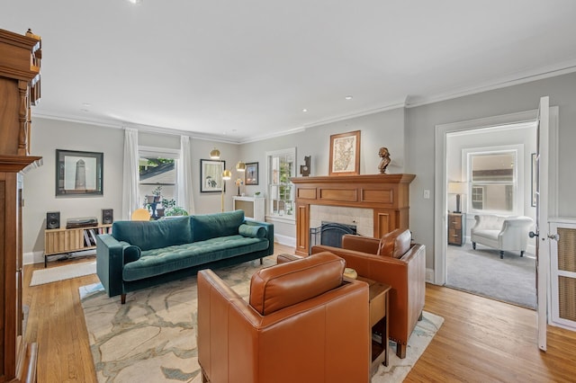 129 50th St, Minneapolis, MN 55419 - living room featuring a tiled fireplace, healthy amount of natural light, light wood-style floors, ornamental molding, and recessed lighting